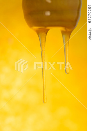 Sweet amber flower honey flows. Liquid stream of 62270204