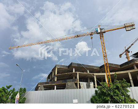 BANGKOK, THAILAND- October 14, 2019: Tower crane in construction site against cloud and blue sky at BANGKOK, THAILAND. BANGKOK, THAILAND- October 14, 2019: Tower crane in construction site against cloud and blue sky at BANGKOK, THAILAND. 62270523