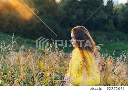 Cheerful smiling teenage girl of 14 years old with long curly red hair 62272071