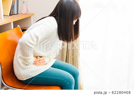 腹痛の女性　病気や妊娠など様々な症状 62280408