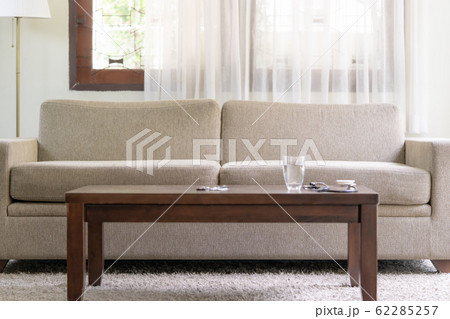 Empty sofa with with water and medicine tablet on 62285257
