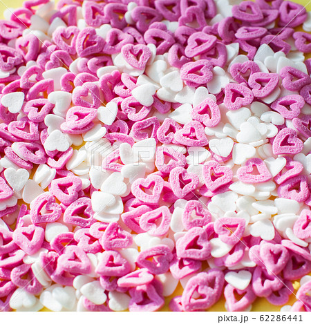 Purple and white heart shaped confetti background. Purple and white heart shaped confetti background. 62286441