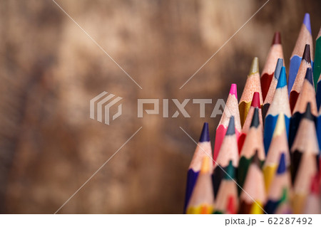 A group of bright wooden pencils on a wooden A group of bright wooden pencils on a wooden 62287492
