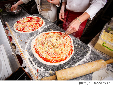 Two pizzas on the table, ready for bake 62287537