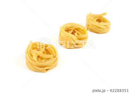 nest of tagliatelle pasta isolated on white background. nest of tagliatelle pasta isolated on white background. 62288351