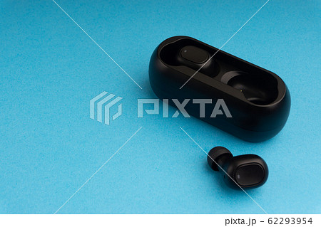 Wireless earbuds or earphones on blue background 62293954