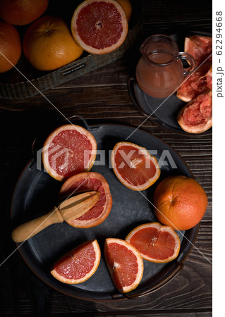 Juicer with squeezed grapefruit half on dish Juicer with squeezed grapefruit half on dish 62294668