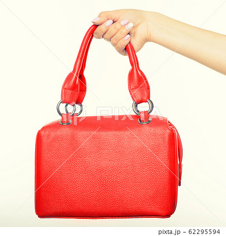 female hand holding red bag isolated female hand holding red bag isolated 62295594