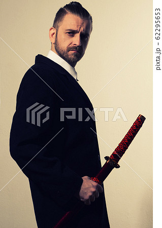 businessman in a black suit with a samurai sword businessman in a black suit with a samurai sword 62295653