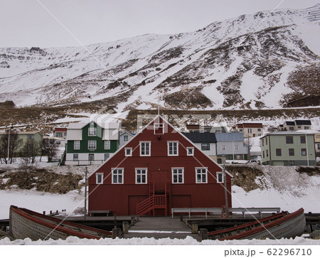 Red wooden house in front of snow covered mountain 62296710