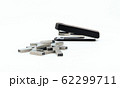 Black stapler and metal staple isolated on a white 62299711