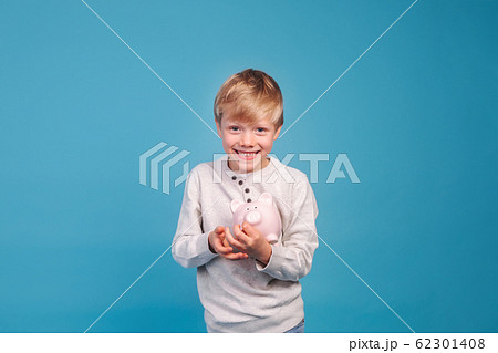 children's pocket money. Little boy with piggy Bank children's pocket money. Little boy with piggy Bank 62301408