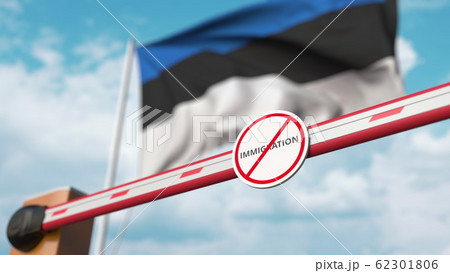 Closed boom barrier with stop immigration sign against the Estonian flag. Border closure or immigration ban in Estonia. 3D rendering 62301806