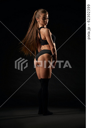Woman in lingerie and knee socksposing. 62302399