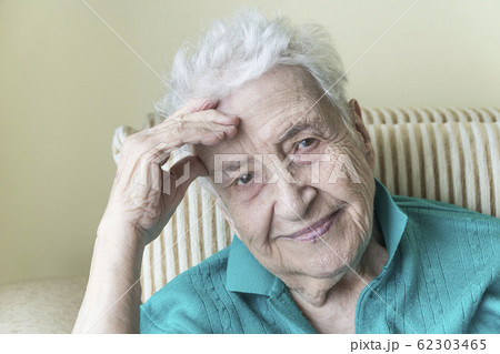 closeup wrinkled face of an old woman smiling closeup wrinkled face of an old woman smiling 62303465