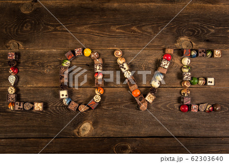 LOVE word arranged with pralines on the wooden LOVE word arranged with pralines on the wooden 62303640