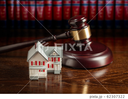 Gavel and Small Model House on Wooden Table. Gavel and Small Model House on Wooden Table. 62307322