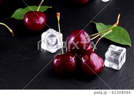 Close up of pile of ripe cherries with stalks and 62308094
