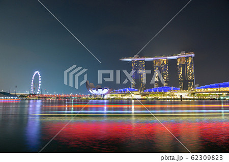 panorama background of Marina Bay, Singapore City at night with long exposure light of boat. panorama background of Marina Bay, Singapore City at night with long exposure light of boat. 62309823