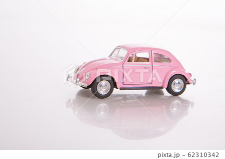 pink toy model of a real car on a white background. The concept of international women's day, happy birthday, Valentine's Day, gift Souvenirs, collectible cars. copy space 62310342