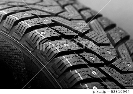Close-up side view of a large studded tire 62310944