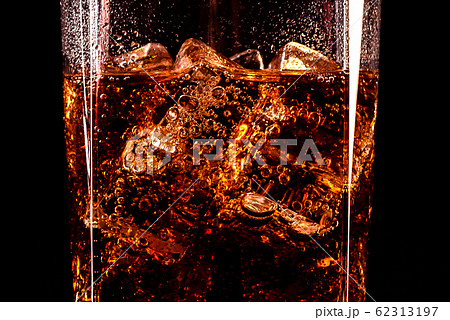 Cola glass with ice cubes and droplets 62313197