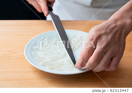 ふぐ薄造りを盛り付ける板前 62313447