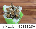 Withered roses on wood floor 62315260