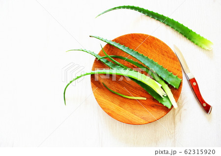 Leaf of fresh aloe vera on wooden plate , natural clear gel 62315920