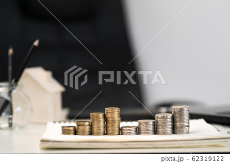 Silver and gold coins stacked on the work 62319122