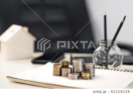 Silver and gold coins stacked on the work 62319128