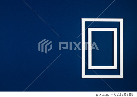 Empty wooden picture frame on a blue classic background 62320289