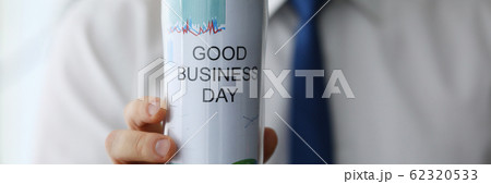 Man hold in hand thermal flask with hot beverage closeup 62320533