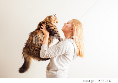Young woman holding new adopted siberian cat 62321611