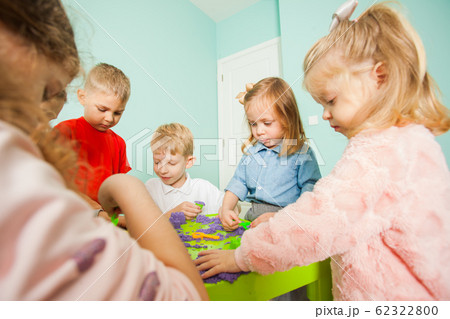 Children playing and having fun with kinetic sand Children playing and having fun with kinetic sand 62322800