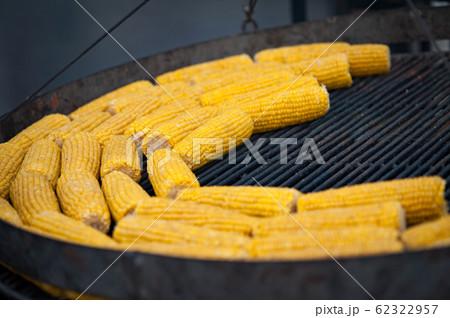 Grilled corn. Street food festival. Close up of appetizing grilled sweet corn on the bbq grill. 62322957