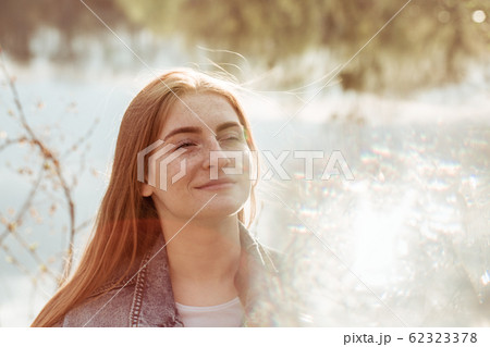Portrait of a young beautiful redhead woman with Portrait of a young beautiful redhead woman with 62323378