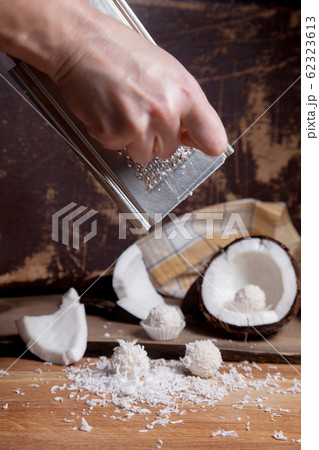 Close up of coconut with white pulp, grater with 62323613