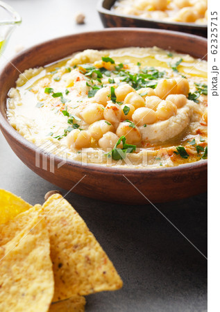 Closeup view at Hummus topped with beans olive oil Closeup view at Hummus topped with beans olive oil 62325715