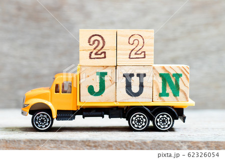 Truck hold letter block in word 22jun on wood background  62326054