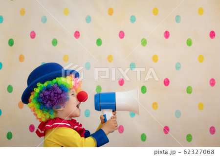 Funny kid clown playing indoor Funny kid clown playing indoor 62327068