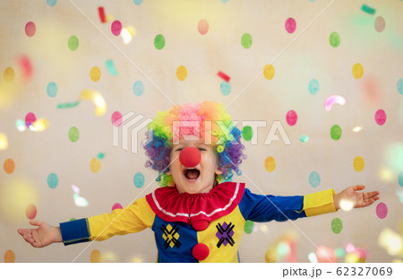 Funny kid clown playing indoor Funny kid clown playing indoor 62327069