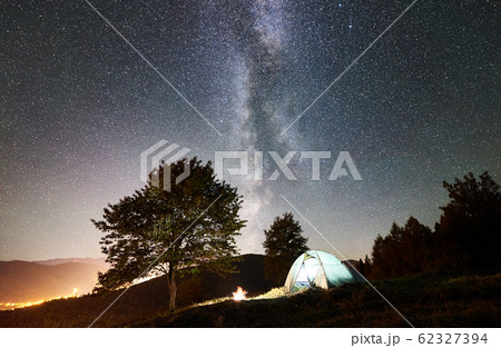Tourist camping and tent under night sky full of stars 62327394