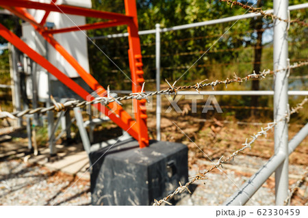 barbed wire fence around a cellular tower barbed wire fence around a cellular tower 62330459