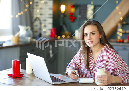 Female freelancer making notes at home 62330649