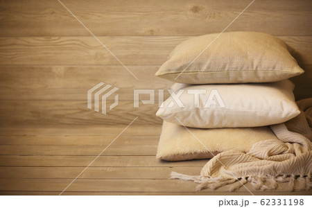 Pile of ornamental pillows with plaid 62331198