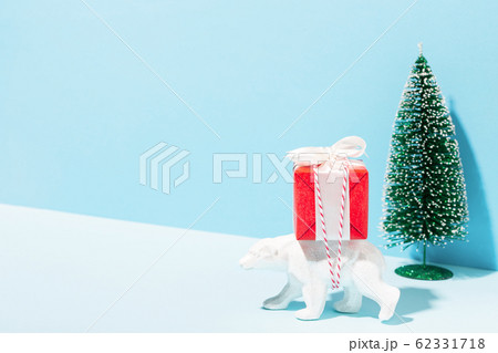 A toy bear delivering a Christmas gift. 62331718