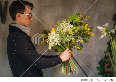 Flower shop make bouquet for a holiday. Family flower's business. Beautiful flower composition. Detail. Close up 62332170