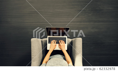 Woman using a laptop computer Woman using a laptop computer 62332978