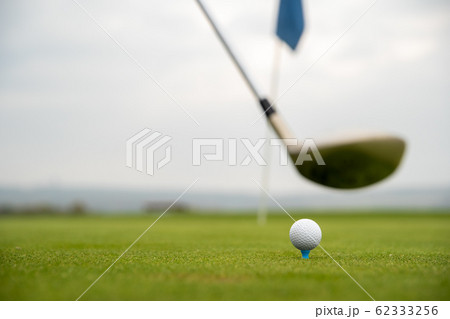 golf game on green course with ball and stick 62333256